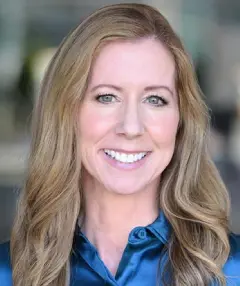 A woman with long hair and a blue shirt.