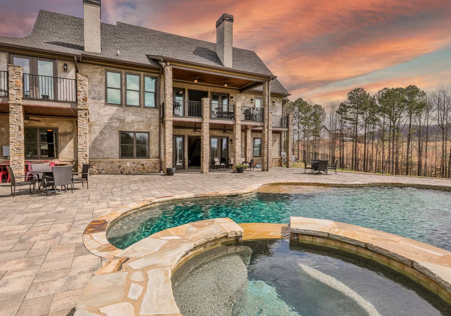 A large pool with a hot tub in the middle of it.
